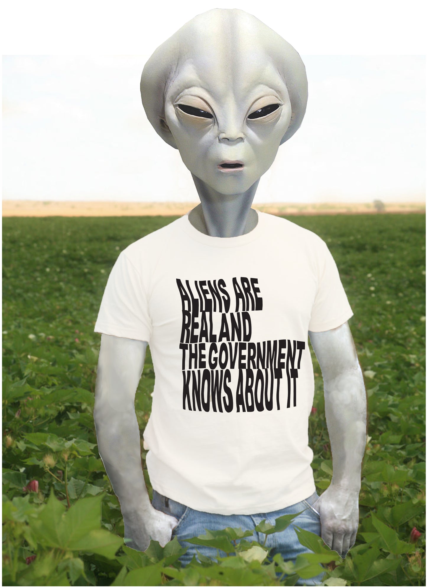 t-shirt computer mock up of alien standing in a field of cotton wearing a white t-shirt with text printed on it that reads aliens are real and the government knows about it